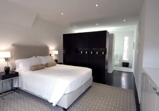 The master bedroom, with a doorless master bathroom beyond.
