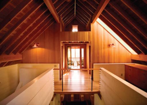 The second floor, which is entirely within the roof structure, houses a master bedroom suite.