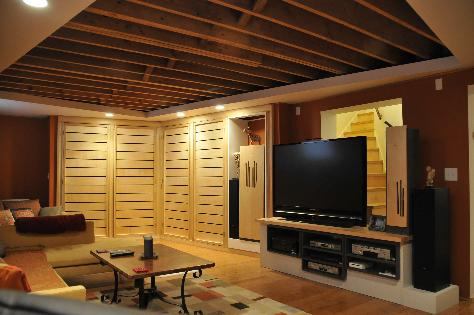 Exposed joists add a unique visual element as well as height to the low-ceilinged rom. 131Shapes sanded and used a clear finish on the joists, then built a bulkhead around the mechanicals.