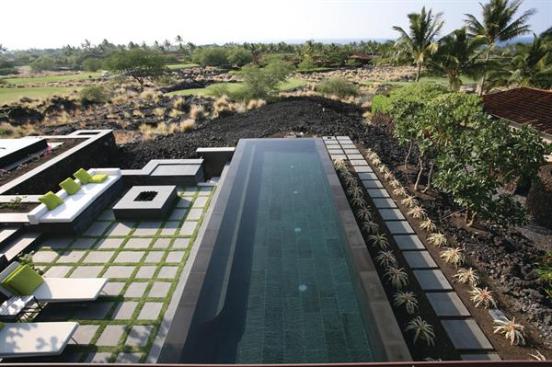 Seating, a fire pit, pool, and spa extend the main living space outdoors.