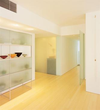 The apartment's original concrete slab ceiling prohibited architect Eddie Jones from adding conventional recessed lighting. Instead, he downlit soffits and uplit coves to gain extra illumination.
