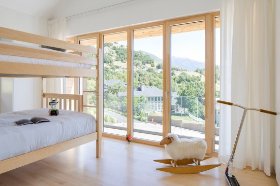 The home’s simple material palette continues into the minimalistic bathrooms and even the upstairs children’s bedroom.