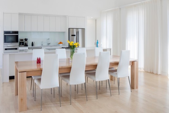 The Canadian maple dining table occupies the center of the barn space and was designed specifically for the home.
