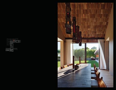 Shingled ceilings give interior spaces an outdoor feeling. The chimneys are sheathed in blackened steel.