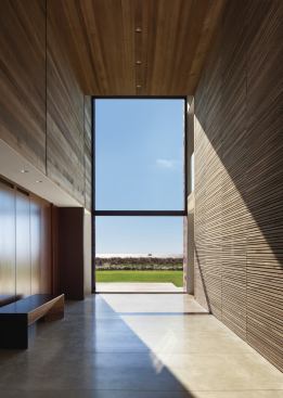 The entryway frames a layer-cake view of land, sea, and sky.