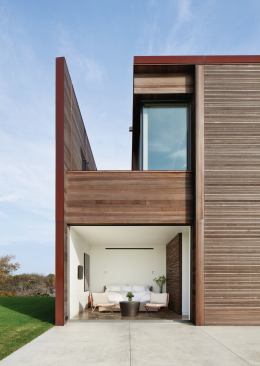 Cedar-strip siding panels—bracketed by rusted steel end walls--lend a fine-grained precision to a building whose sheer size might otherwise overwhelm. 