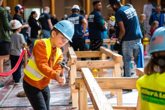 Driving nails at Miller & Long’s nail-driving contest, a classic activity station at The Big Build.