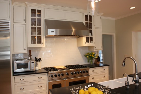 This farmhouse had received several updates and renova-
tions over the years. However, the floor plan was conflict-
ing amongst the kitchen, laundry, mudroom, and powder 
room. A complete reorganization of the first floor was 
achieved through multiple structural changes that al-
lowed for a larger kitchen and created better flow be-
tween adjacent rooms. The kitchen includes custom 
painted cabinetry, a farmhouse style sink, and soapstone 
countertops. A commercial size Viking range, hood, and 
Sub Zero refrigerator bring a theme of stainless steel to 
the kitchen which is accentuated by brushed nickel hard-
ware and island faucet. Specialty lighting, glass door 
cabinets, and a grand, eight foot island are just a few of 
the features that make this kitchen stunning.
