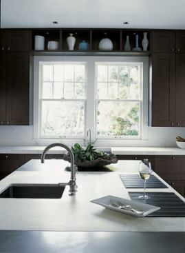 The sculptural center island is topped by three-inch-thick, honed Calcutta marble.