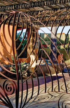 Shadows cast by the ironworks seashell and wave motifs animate the ground plane.
