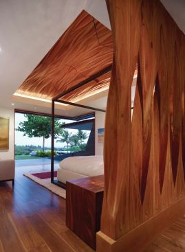CNC-cut glulam beams evoke palm fronds on the master bedroom’s headboard and ceiling.