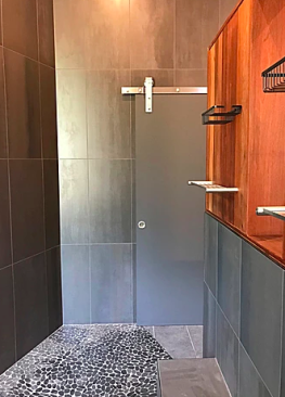 The closed "barn door" provides privacy for the water closet in an otherwise open space.