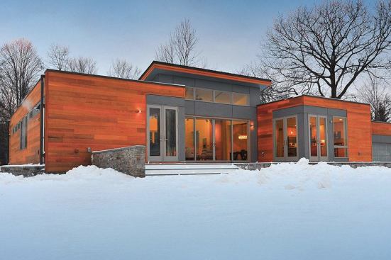 This modular home built on the California coast then packed flat for a cross-country trip to New York State shows no outward signs of its journey.
