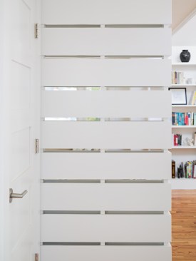 The slatted screen is a custom detail that adds definition to the open space.