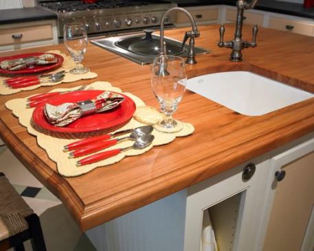 Recyled, reusmed, and low-impact materials were used to the extent possible. The island countertop was made from reclaimed beech from an elementary school floor.