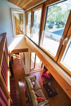 A band of dormer windows light the play loft and living spaces below. With minimal BTUs needed to heat the well-insulated house, the radiant tubing is limited to area rug locations, providing less heat more efficiently at a slightly higher temperature.