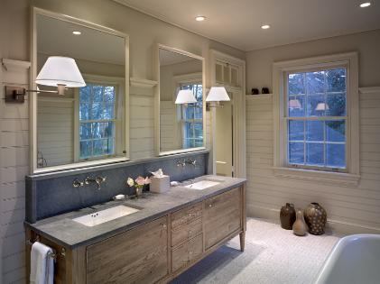 Tongue-and-groove wood paneling is maintained throughout each wall, melding the axes of the space.