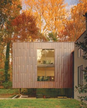 A sleek beauty pervades the project, from the delicate copper pavilion to the understated stucco volume to the custom built-in cabinetry.