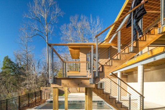 The staircase leading from the main living space down to the pool.