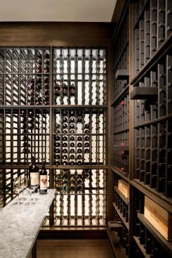 Slatted paneling admits diffuse light into the wine cellar.