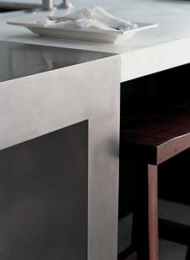 The oversized island is supported by nickel-plated, L-shaped supports that create a sense of airness without sacrificing counter space.