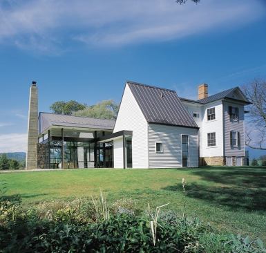 From the glass pavilion's roofline to the bath/mudroom's white clapboard cladding, Bob Gurney's design for this Blue Ridge farmhouse addition—the 2003 Project of the Year—pays tribute to the old house. For more information on this project, 
click here.