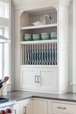 Built in shelves provide a decorative storage space and are a change from traditional cabinets. Project: Cape Cod Beach House by REEF 
