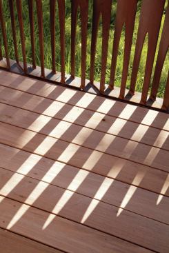 The steel fins extend down and are anchored into the concrete slab beneath the ipe deck. This adds strength and durability to the fence. The concrete was formed into a lip around the deck and painted black to create a decorative frame as well as a sort of shower pan. The deck slats are loosely spaced so the water flows through into the concrete slab where it is then directed into the home’s septic system. The ipe decking was left untreated so it will fade to a silvery-gray. 