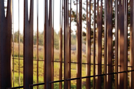 The studio addition features bonderized steel on the roof overhang, so using steel for the shower fence was a logical choice because it was already part of the material palette. The fence was treated so it shouldn’t rust quickly, but will patina slowly over time.