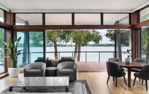 Multislide doors with roll screen walls open to welcome the outdoors in. Automated screens lower at the touch of a button to enclose the porch for comfortable evenings