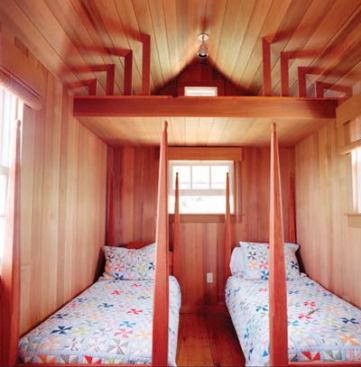 New cedar paneling and salvaged wide-plank flooring to match the original give the interior a warm, familiar feel, while new cabinets, light fixtures, and Duravit plumbing products make it fresh and contemporary.