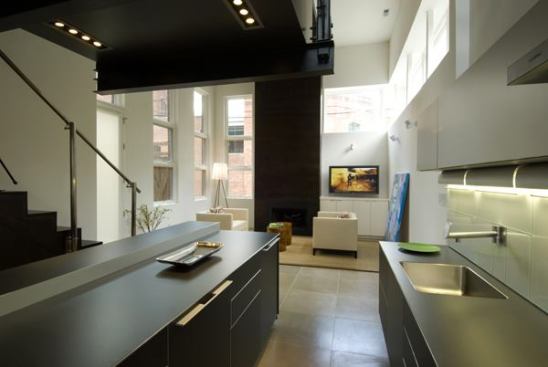 In this 'little skyscraper,' tall and narrow, Division One Architects brightened the spaces with windows and an open stairwell. Floating, wall-mounted Bulthaup b3 cabinets (the first time these cabinets have been used in Washington, D.C.) give the kitchen a lighter feel.
