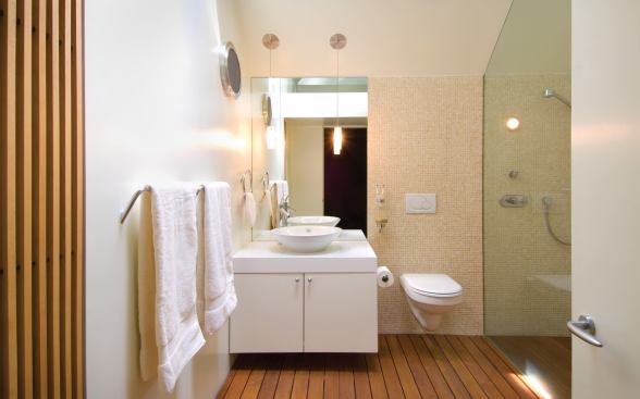 The master bath showers its clean, geometrical elements with a splash of daylight from above.