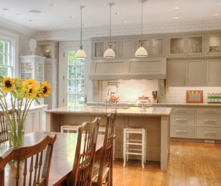The kitchen's cabinet profiles, subway tile, and hardware match those of the bath, lending a welcome sense of consistency. 