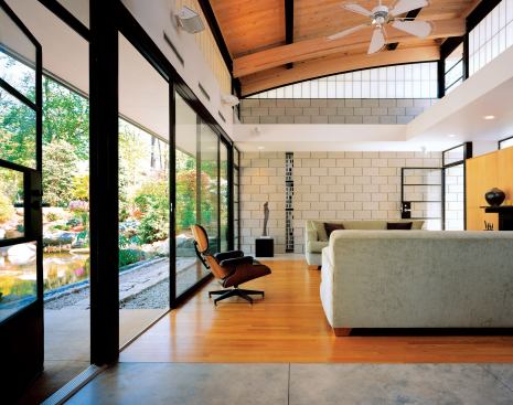 The home's oversized sliding doors, ceiling fans, and many operable windows allow for cross-breezes and natural air circulation.