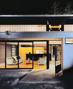 Outdoor rooms like the dining patio, left, and side yard, this page, function as extensions of the house. Projecting downspouts let rainwater become part of the overall design.
