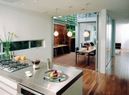 Sight lines from the kitchen and bath into other rooms expand the perceived size of both spaces.