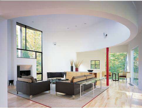 The big, open great room contains multiple functional areas subtly separated by ceiling treatment and built-in cabinetry.