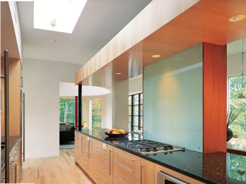 Whether in one of the owners' offices, kitchen, bedrooms, or living area, maple and mahogany cabinetry unifiesthe entire house.Views from the screen porch are controlled with a Galvalume wall.