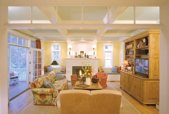 Period-style detailing like a coffered ceiling and built-in bookcases ensures compatibility between the home’s exterior and interior.