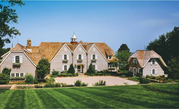 Skirl siding, oversized gables, and custom shutters and flowerboxes bestow a storybook character on the house and the husband’s home office (below, right).