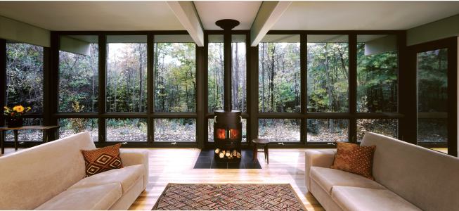 The highest calling of this northern Michigan vacation home is to get out of the way, and to that end it places a minimum of structure between its occupants and the dense forest that surrounds them.