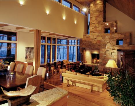 The kitchen/dining/ living wing focuses on an elaborate chimney, whose rough stone masonry contrasts with an inner fireplace surround of cut limestone.