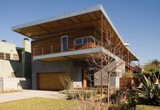 Occupying a narrow lot in an estabished neighborhood, this new house creates a surprising number and variety of outdoor living spaces.