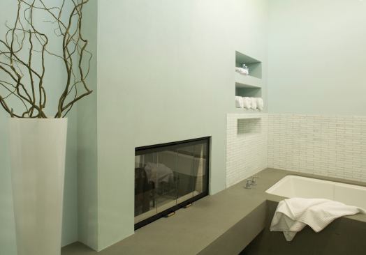 A two-sided gas fireplace serves both bath and bedroom.