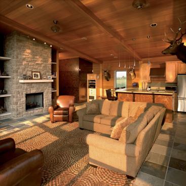 The boathouse's interior materials echo its exterior palette of wood, stone, and metal.