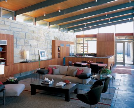 Interiors combine high style with the easy maintenance and bulletproof durability of sandstone walls and concrete floors. Cherry millwork adds a warming counterpoint.