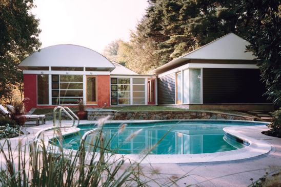 The renovated house is a sequence of pavilions articulated by varied colors, finish materials, and roof lines. Large expanses of glass along the rear elevation help blur the distinction between indoor and outdoor spaces.