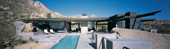 For the most part, the site's massive granite boulders and cacti were left intact. Below, warm wood ceilings continue from interior to exterior spaces.