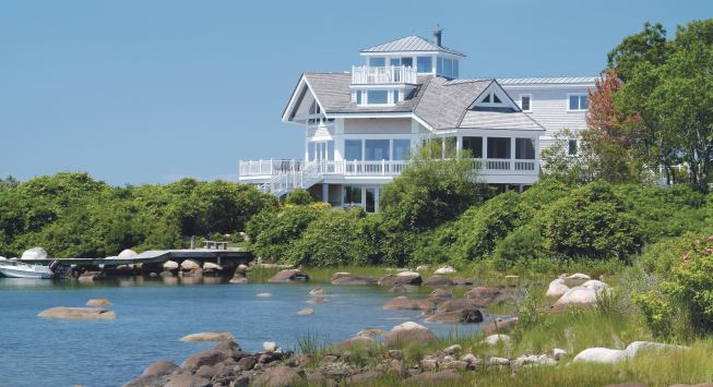 Lots of decks, well-placed windows, and a widow's walk take in the longreaching views afforded by the home's prime site on a rocky promontory.
